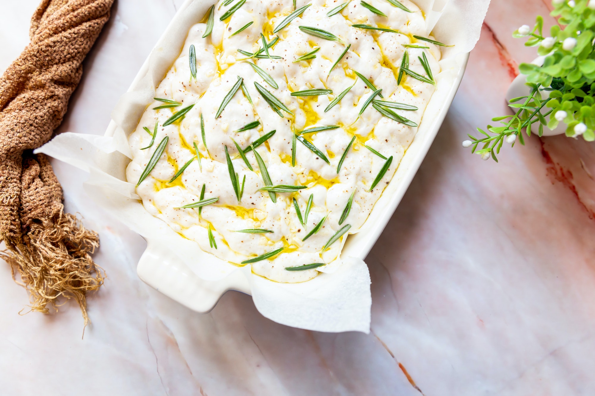 Focaccia bread with rosemary and garlic ready to go in the oven
